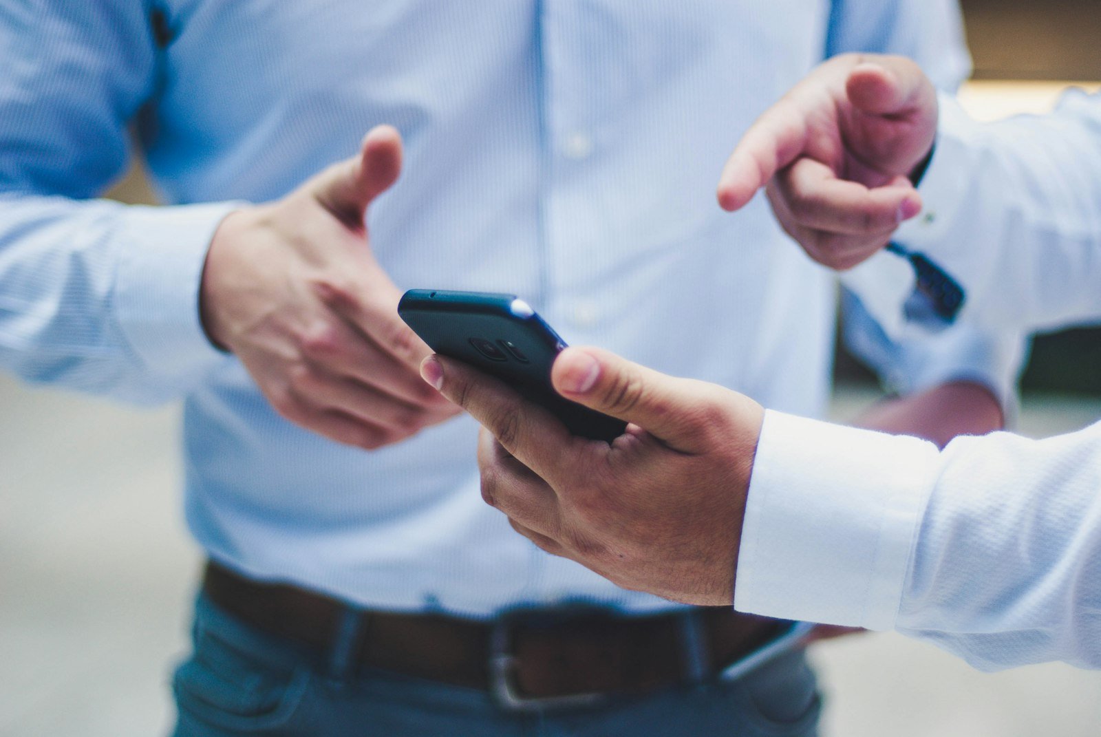 Two people handing over a smartphone