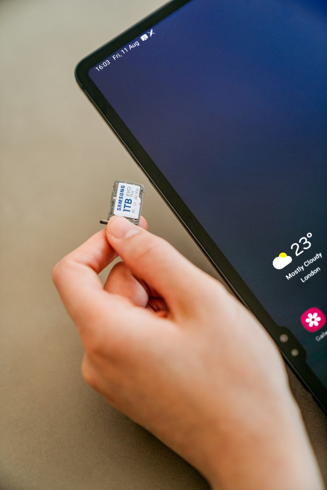 Hand inserting a SIM card into a phone
